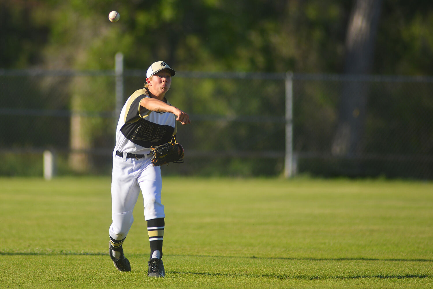 Brodyn Lambert launches a ball into the infield after running out to be a cutoff
